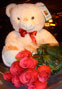 A set of a large soft toy and a bunch of 7 long stem roses 